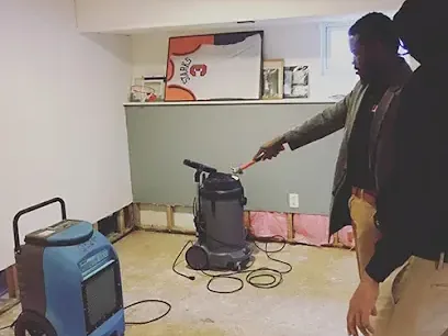 A dehumidifier running in a finished basement after the lower drywall was cut out