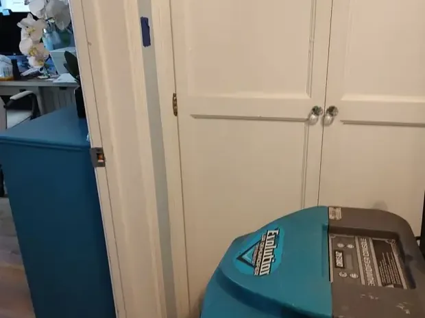 A dehumidifier working from a hallway closet during structural drying