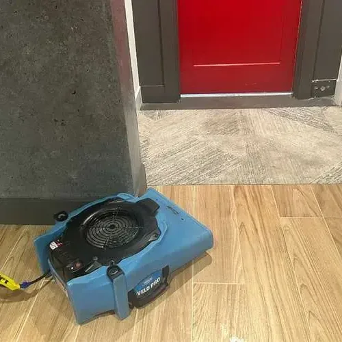 Air mover drying wood-look tile by a doorway for an Oak Harbor claim